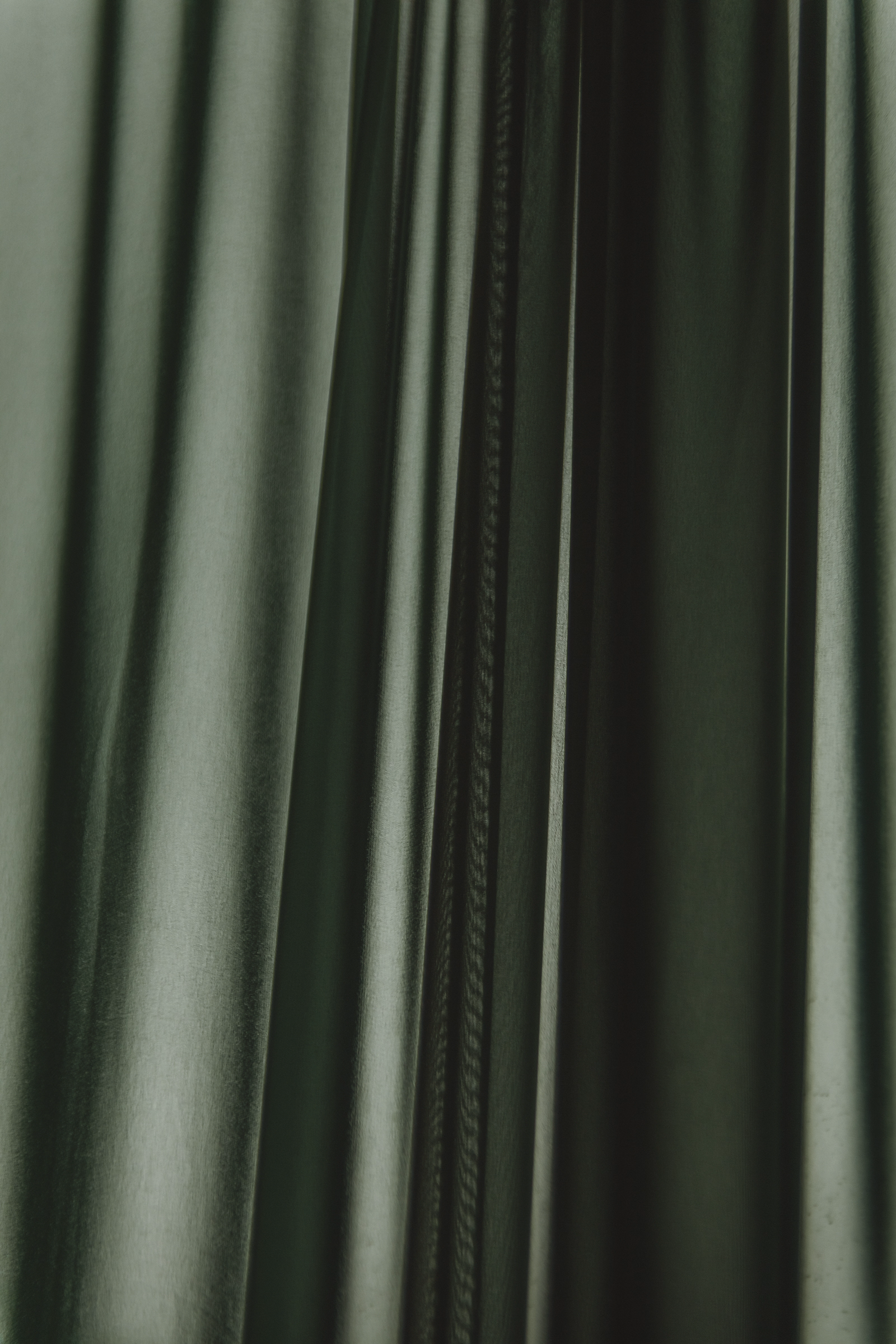 Luxurious Green Satin Fabric Draped Folds Close-Up
